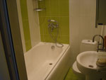 Deluxe double 2 - a bathroom with a bath